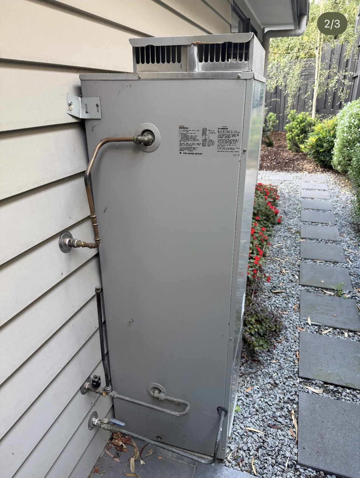 Old rusted hot water system before replacement
